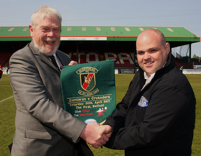 James Scott, FASA presents Brian Gilliland, Director of Glentoran Football Club with a Pennant